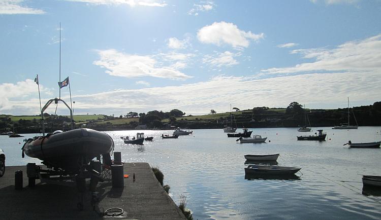 Blue skies over a small and perfectly still harbour at Castletownsend