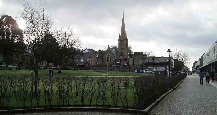 Fort william town centre with a grassed area, church and shops