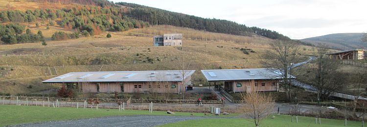 glentress mountain bike centre, 2 large buildings made of wood that fit into the surroundings