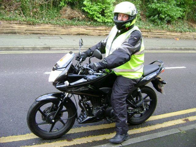 Monk on his honda cbf 125 and dayglo bike gear