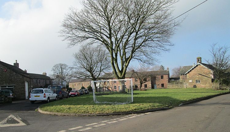 The village of Winton. Village green, stone built cottages and a large tree