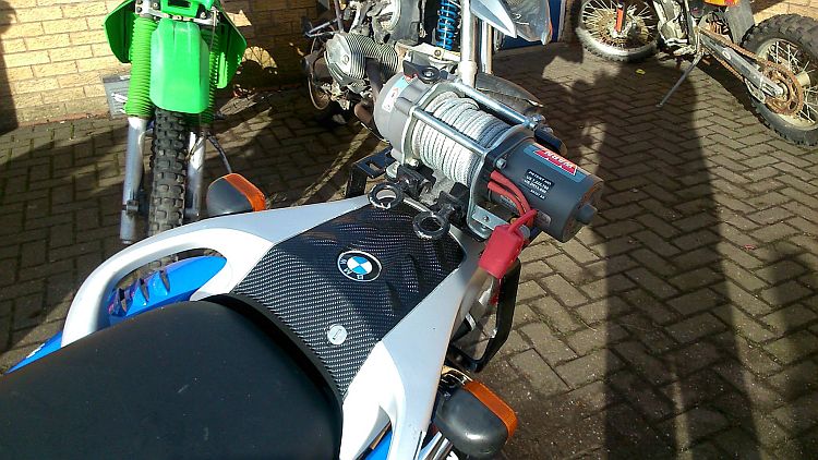 a small but powerful winch fitted to the rear rack of a BMW motorcycle