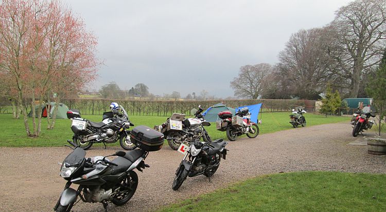 several motorcycles including the 125s at the campsite near kirkby stephen