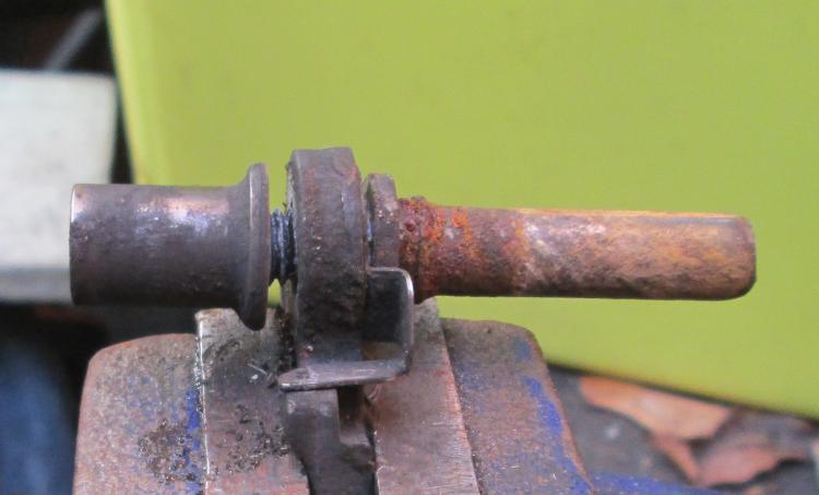 a rusty metal pin, part of the brake that can't be cleaned in situ