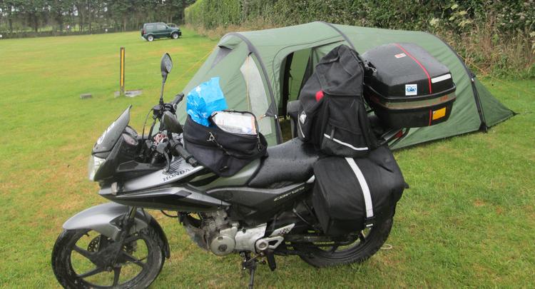 Ren's wet bike outside a wet tent at the campsite near Wicklow