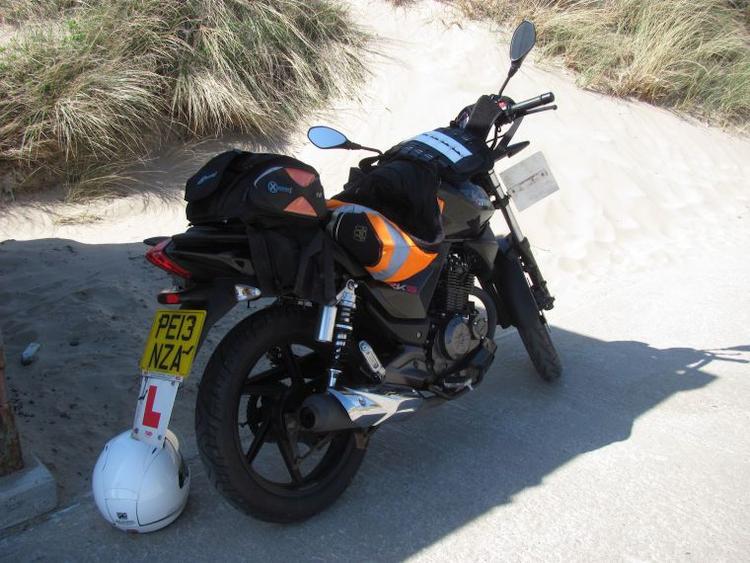 Sharon's Keeway 125 on the sandy bluffs in Wales