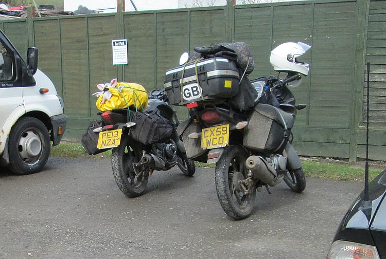 2 very loaded up 125cc motorcycles ready for a camping trip