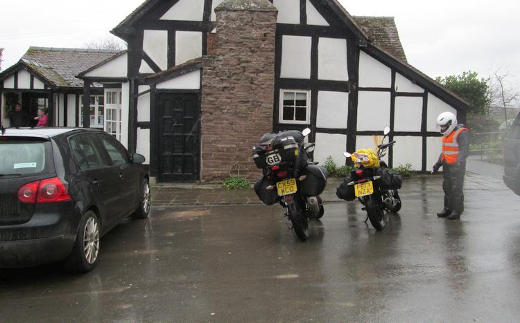 Our 2 wet and dirty motorcycles parked outside The England's Gate Inn