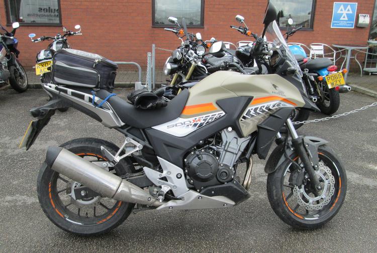 A khaki or light brown CB500X