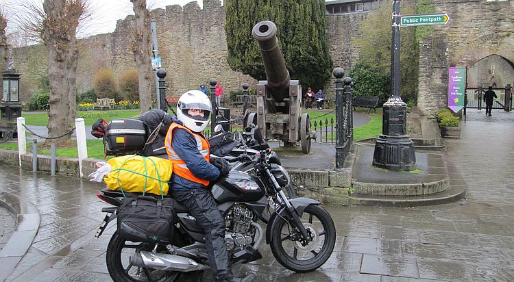 The 2 125 bikes outside Ludlow castle next to an old cannon