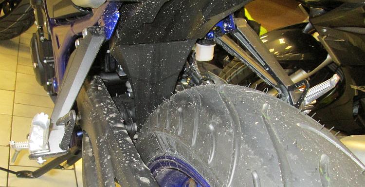 The rear shock is protected from the elements by a long wheel arch
