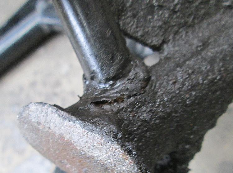 The cracked foot lever weld on the 125's main stand