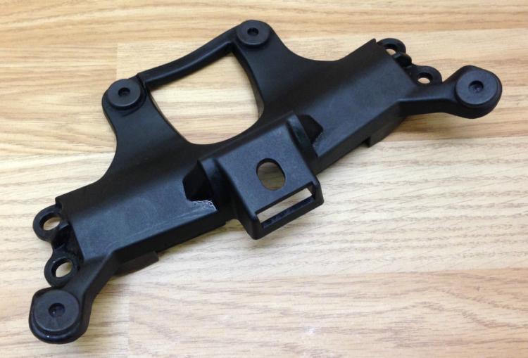 A black bracket that secures the rider's seat on the Striple