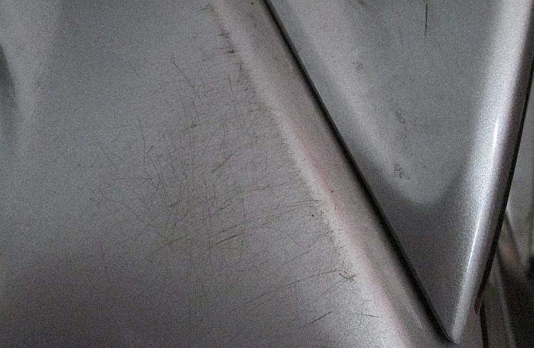 a patch of scratches on the grey paint of Ren's 125