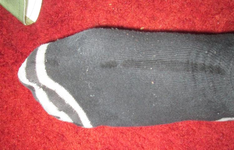 A slightly damp line along the top of the sock after removing from the liner