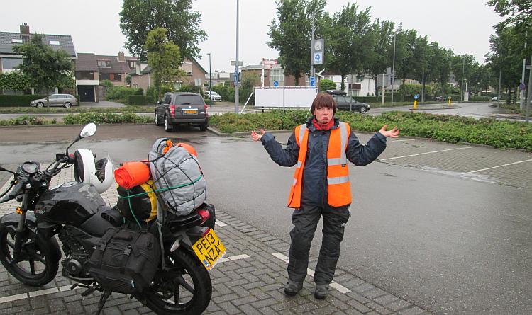 Sharon in the pouring rain in Monster, Netherlands, asking where the sun is
