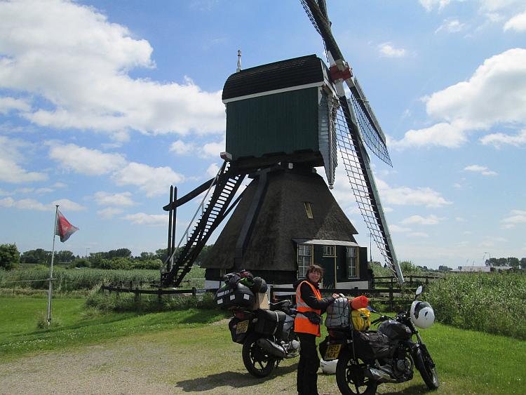 A large old style windmill with the 2 125cc bikes in front of it