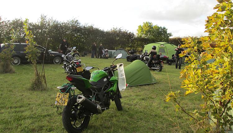 Sharon's 250 in a field surrounded by tents and bikers