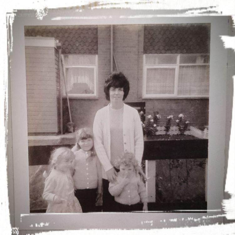 Black and white photo from early 70s, Sharon in the arms of her mother