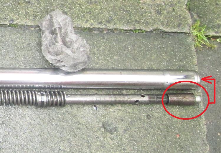 The peculiar part goes in the bottom as shown, then the damper and spring