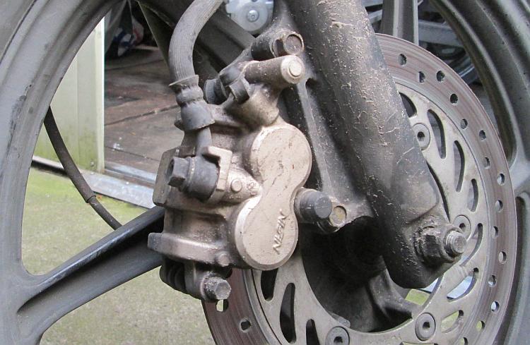 The front brake calliper and disc on Ren's 125