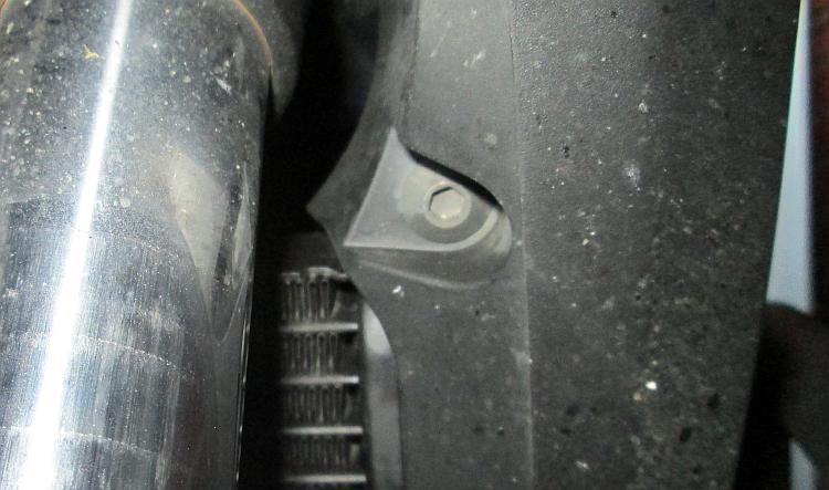 the bolt on the left fairing at the top of the radiator