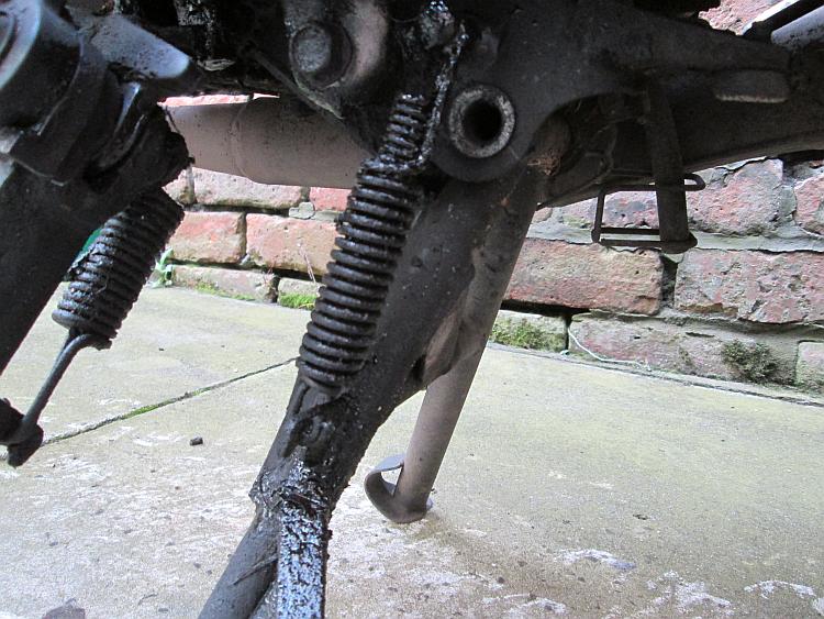 The 125 has oily residue on the centre stand due to lube fling