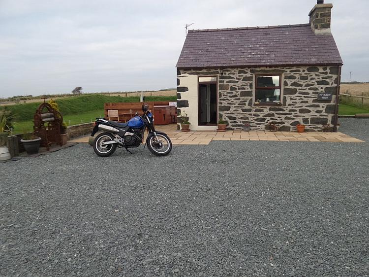 Bob's SLR650 sits outside a tiny but pretty cottage in wales