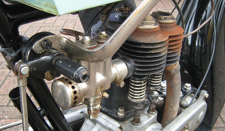 An old vintage motorcycle engine with the workings visible for all to se