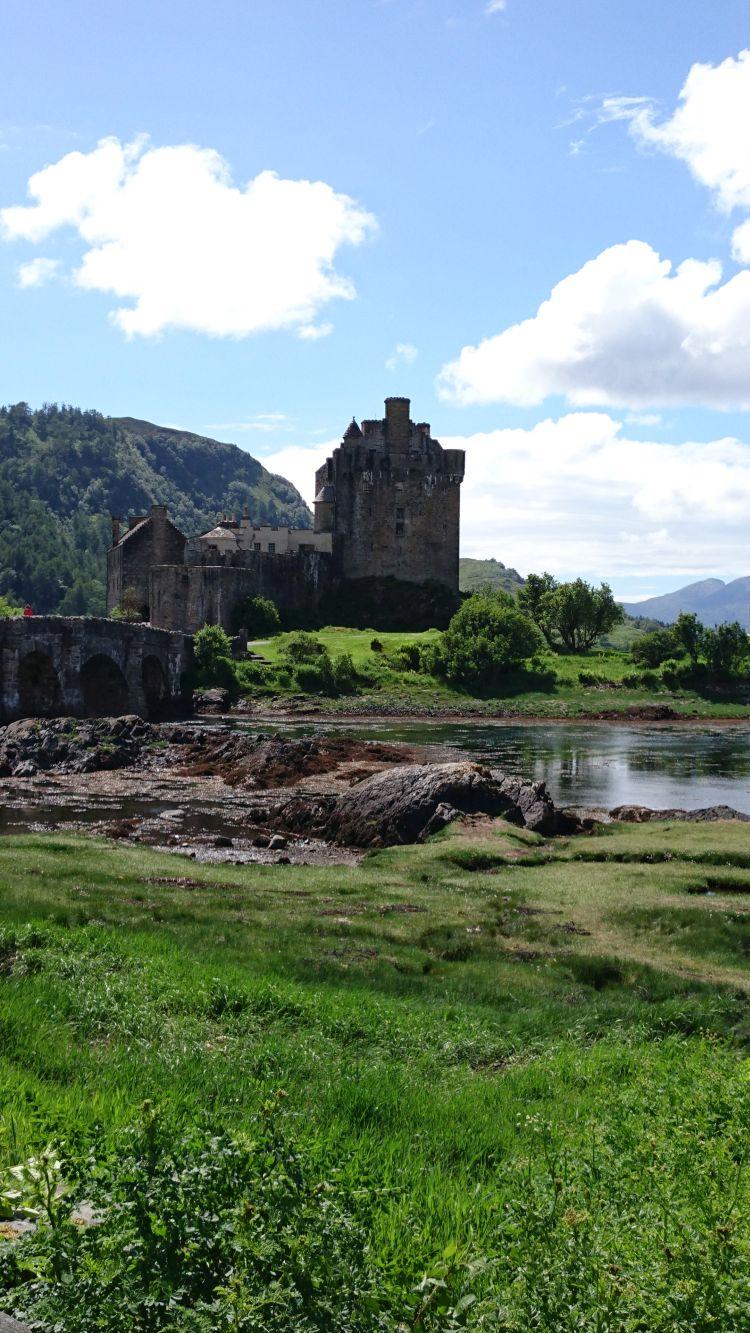 The Eilean Donan castle bathed in sun. The castle is on an island into the loch