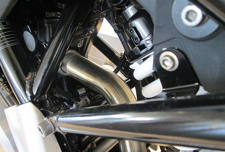 The exhaust exits the engine at the rear of the cylinder head