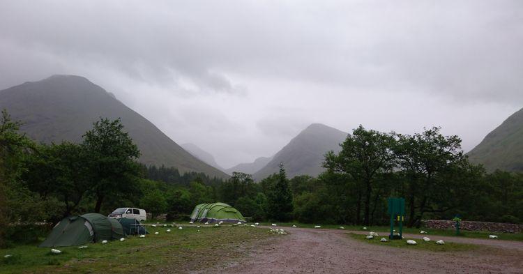 Massive hillsides in the mist and dark clouds at Glencoe and The Red Squirrel campsite