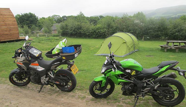 The Honda and Kawasaki next to the tent at Glentress Forest Lodges