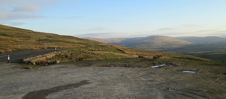 Rolling moorland and hills with blue skies in the setting sun