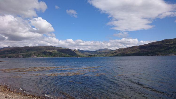 Impressive Loch Carron with blue skies and a little seaweed in the waters