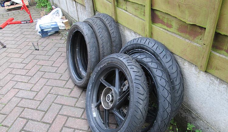 A pile of new and used motorcycle tyres