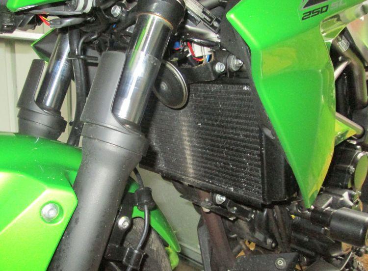 The radiator on Sharon's Kawasaki has a few scratches and marks upon it