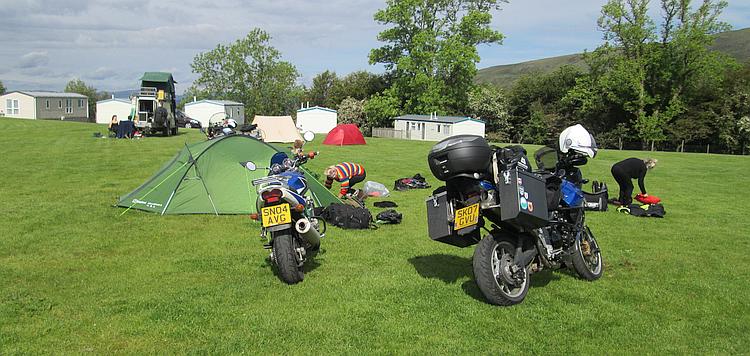 Tents and kit being stowed on motorcycles as our campers pack up ready to depart for the day