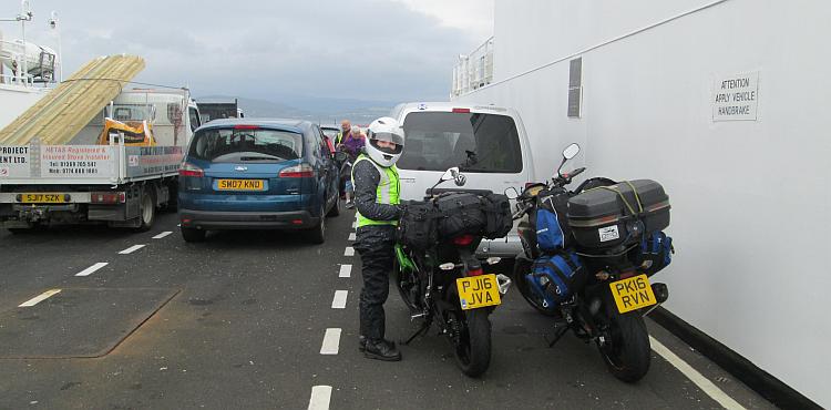 Sharon stands next to her bike on a small ferry crossing the Clyde Estuary
