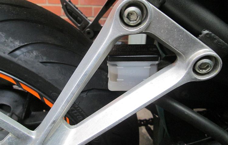 The rear master cylinder on the cb500x is behind the rear footrest