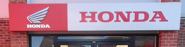 The Honda logo above a honda shop