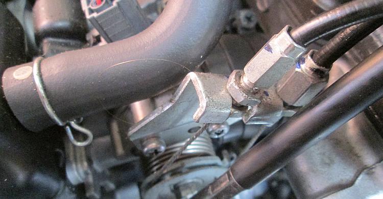 The throttle cables at the throttle body are neat and clean and in good order