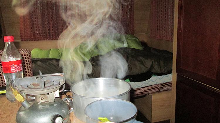 Steam rises from a cup while Sharon sleeps in the caravan in Northern Spain