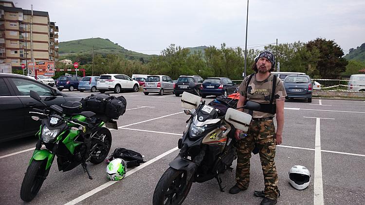 Ren is pulling a really horrible and sad face in a car park near Bilbao