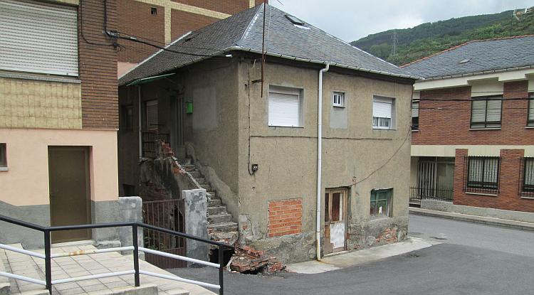 Plain brick and concrete buildings, some stairs that have collapsed