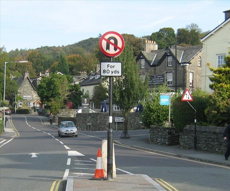 Just a few roads signs on a street in the lake District