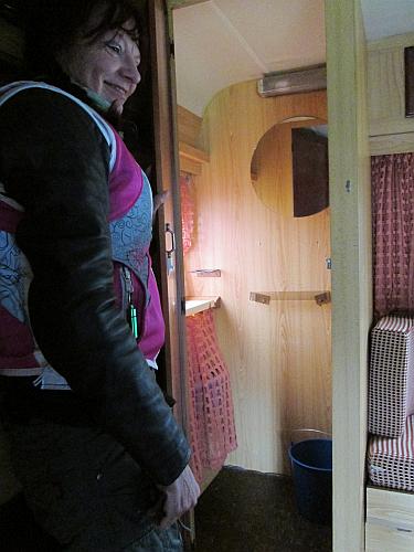 Sharon opens the door to what was once the toilet in the caravan, is now just a bucket
