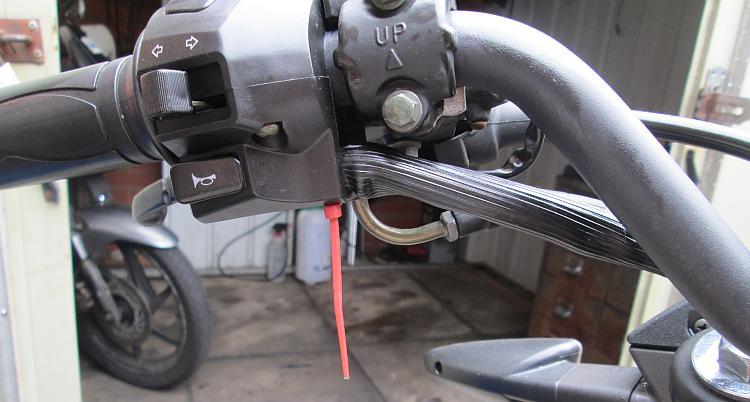 The switchgear is back on the bike but a red zip tie holding the wires looks out of place