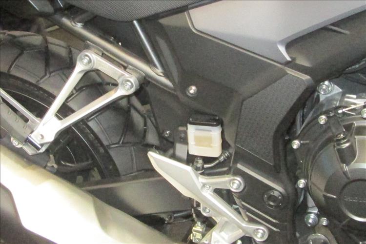 The rear brake fluid reservoir is not pitched inside and above the footrest hanger