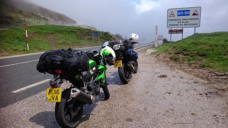 The 2 bikes on the mountain pass with some hazy mist fading nearby
